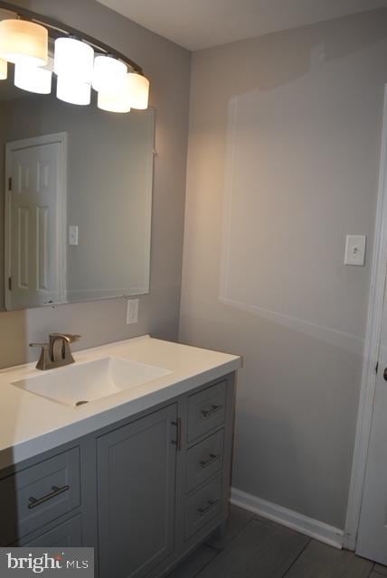 bathroom featuring tile flooring and vanity