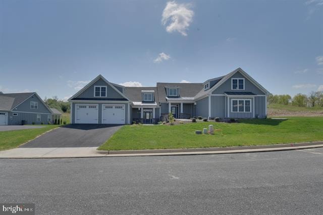 craftsman-style house featuring a front yard and a garage