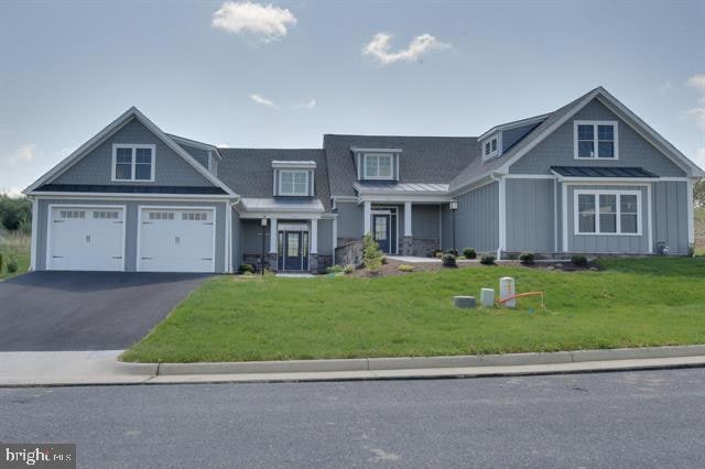 view of front facade with a front yard and a garage