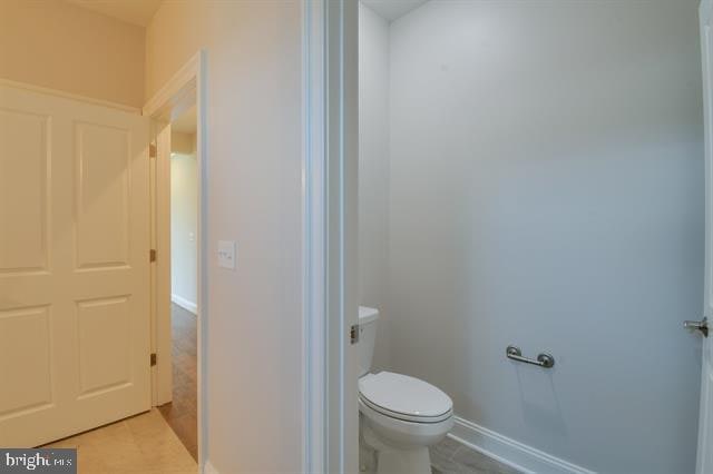 bathroom with tile floors and toilet