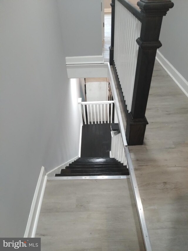 stairway featuring light hardwood / wood-style floors