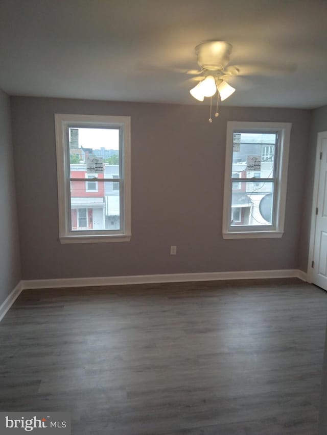 spare room featuring dark hardwood / wood-style floors and ceiling fan