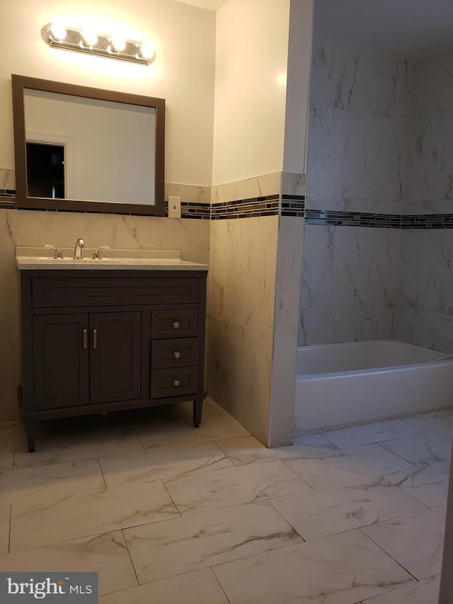 bathroom featuring vanity, tile floors, and tile walls