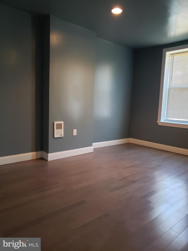 empty room with dark hardwood / wood-style flooring