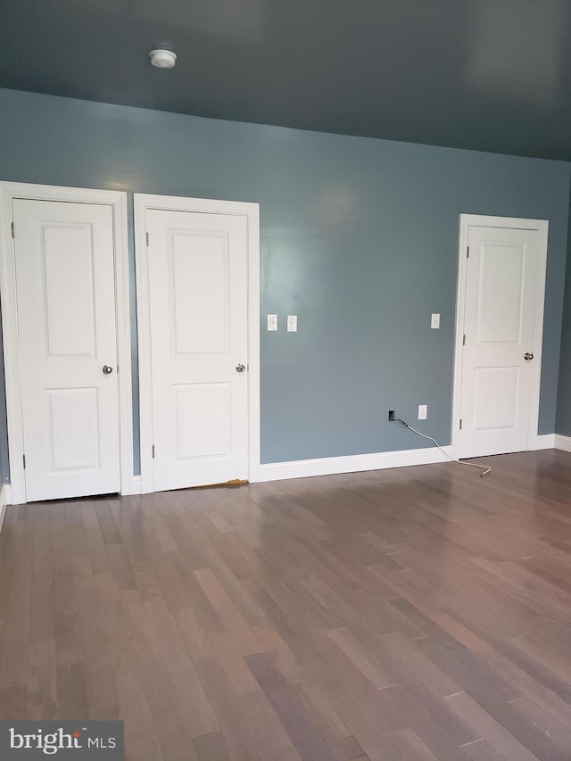 unfurnished room with dark hardwood / wood-style floors