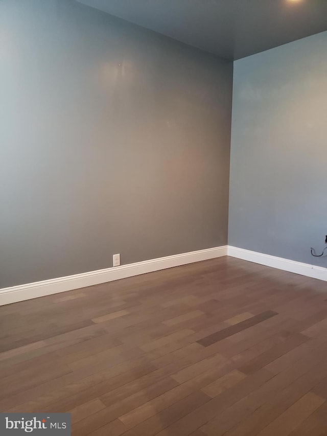 empty room featuring dark wood-type flooring