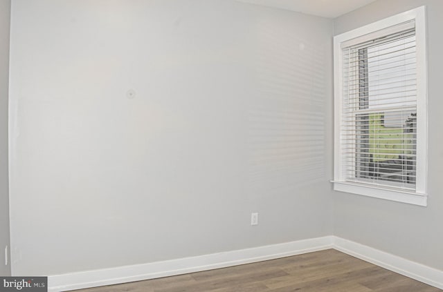 empty room with dark wood-type flooring