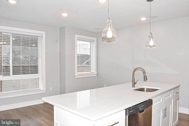 kitchen with dark hardwood / wood-style floors, pendant lighting, sink, white cabinets, and stainless steel dishwasher