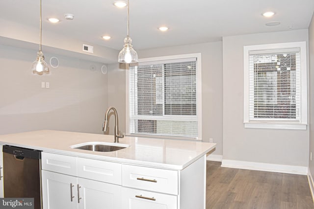 kitchen featuring stainless steel dishwasher, pendant lighting, sink, and white cabinetry