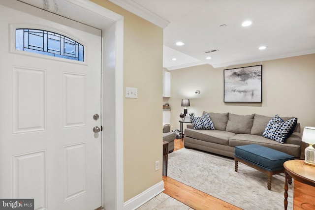 interior space with crown molding and light hardwood / wood-style flooring