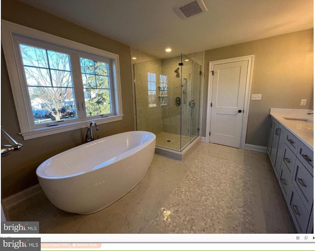 bathroom featuring tile floors, vanity, and independent shower and bath