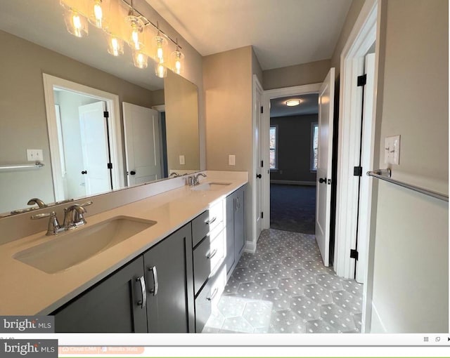 bathroom featuring oversized vanity, tile flooring, and dual sinks