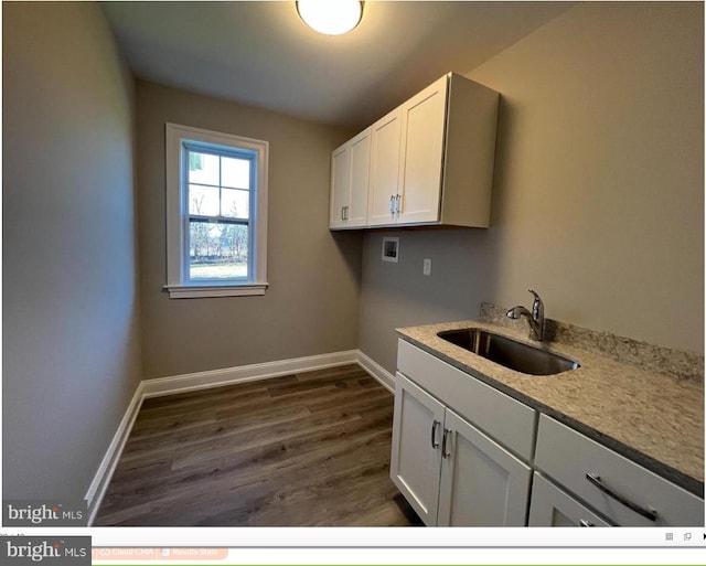 clothes washing area featuring hookup for a washing machine, cabinets, dark hardwood / wood-style floors, and sink