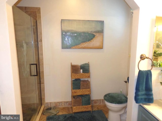 bathroom with an enclosed shower, toilet, vanity, and tile flooring