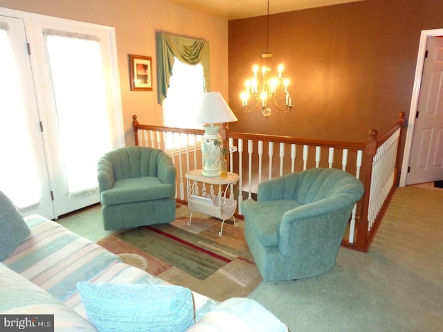 living room featuring carpet and a chandelier