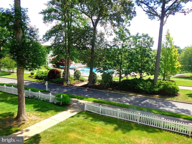 surrounding community featuring a yard and a swimming pool