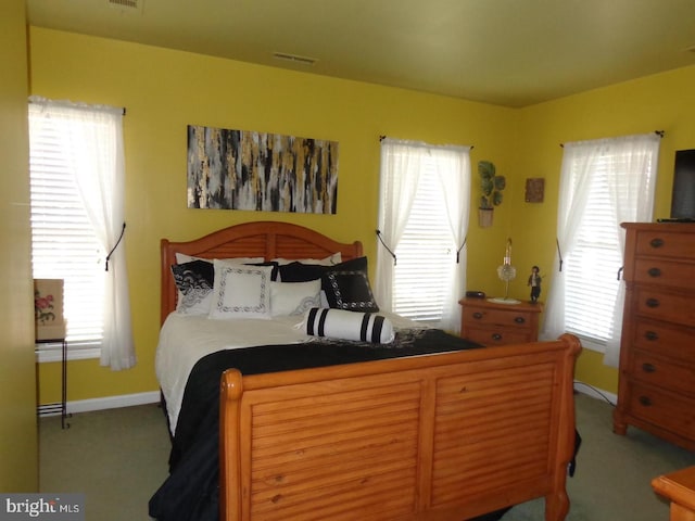 carpeted bedroom featuring multiple windows