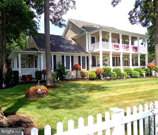 view of front of home with a front yard and a porch