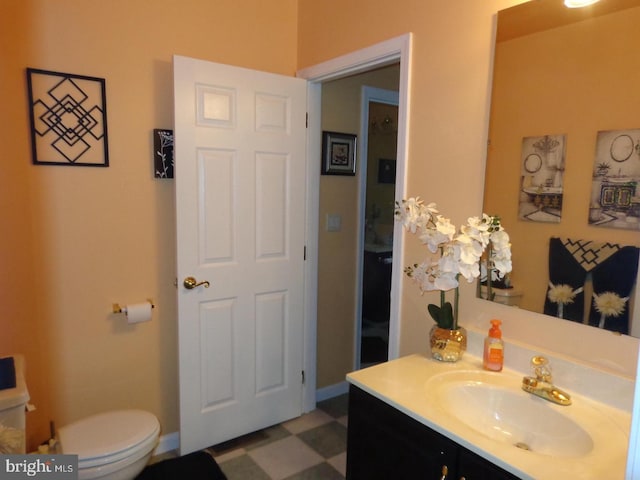 bathroom featuring tile floors, toilet, and vanity