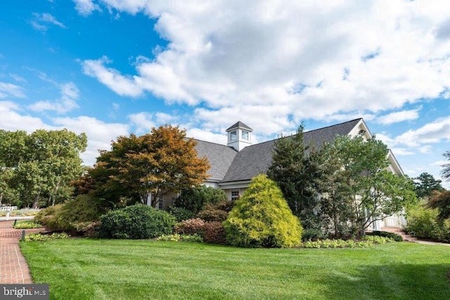 view of home's exterior with a lawn