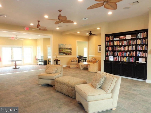 living room with ceiling fan and light carpet