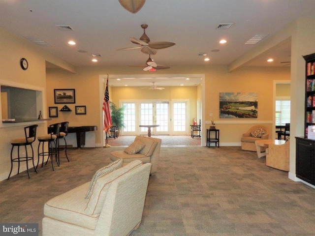 living room featuring ceiling fan and dark colored carpet