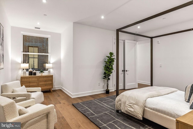 bedroom with wood-type flooring