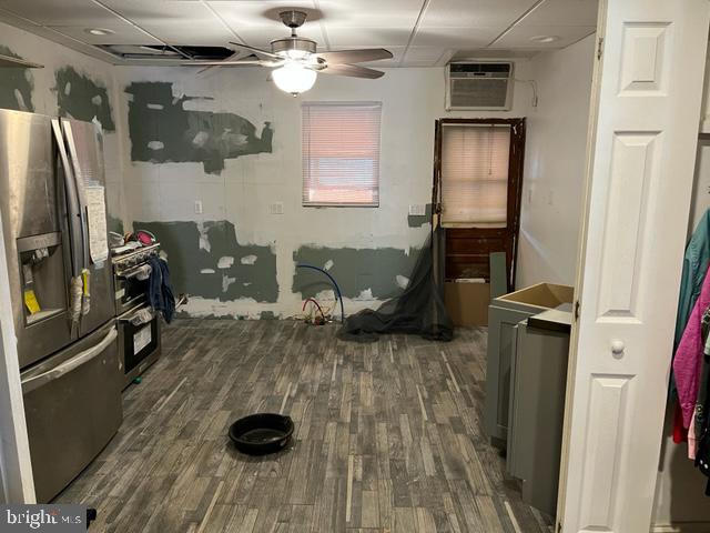 kitchen featuring a paneled ceiling, stainless steel fridge with ice dispenser, ceiling fan, and dark hardwood / wood-style floors