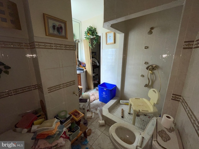 bathroom with tile flooring, tile walls, and toilet