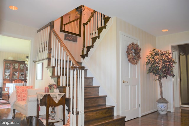 stairway with dark wood-type flooring