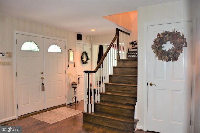 foyer entrance with dark hardwood / wood-style floors