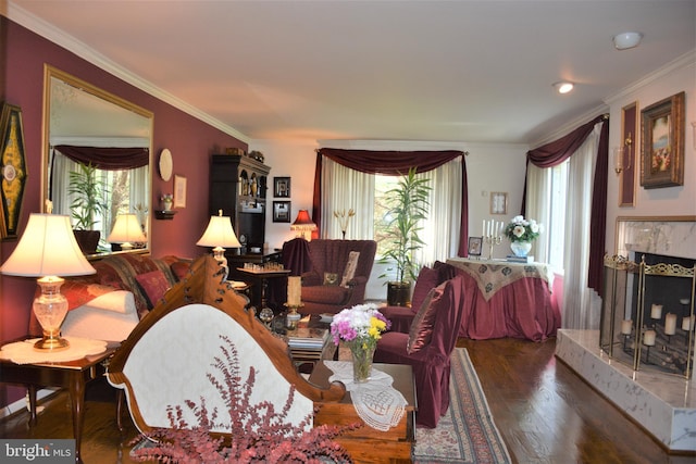 living room with a tiled fireplace, dark wood-type flooring, and ornamental molding