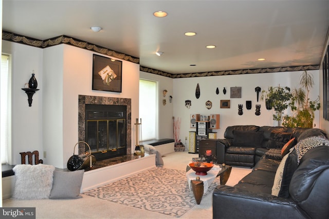 carpeted living room featuring a premium fireplace