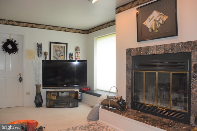 living room with carpet and a tiled fireplace