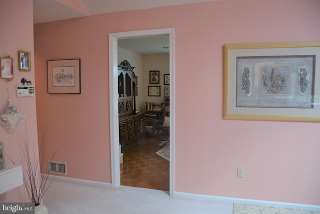 hall featuring light colored carpet