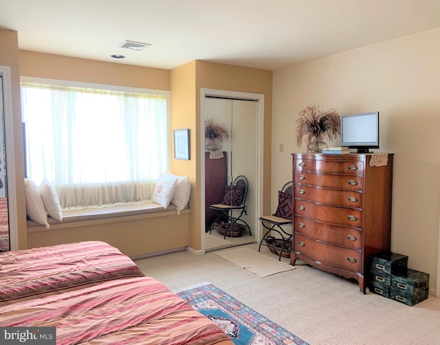 carpeted bedroom with a closet