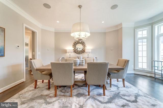 dining area with hardwood / wood-style floors, crown molding, and a wealth of natural light