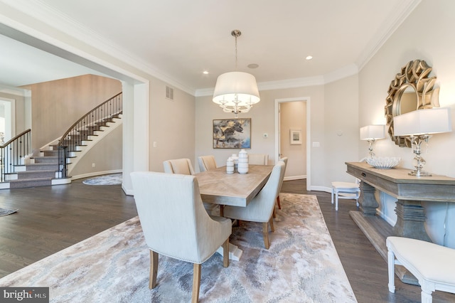 dining room with crown molding, dark hardwood / wood-style floors, and a chandelier