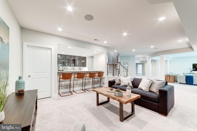 living room featuring light carpet and ornate columns