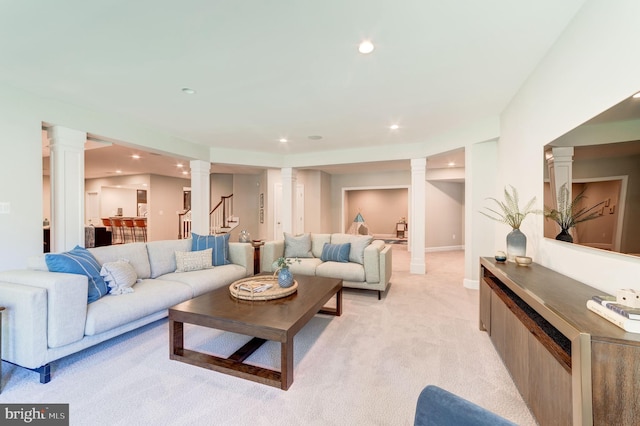 carpeted living room featuring ornate columns