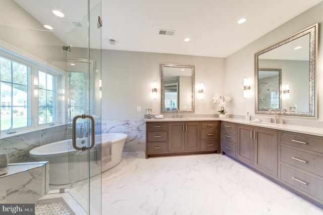 bathroom with shower with separate bathtub, vanity, and tile flooring