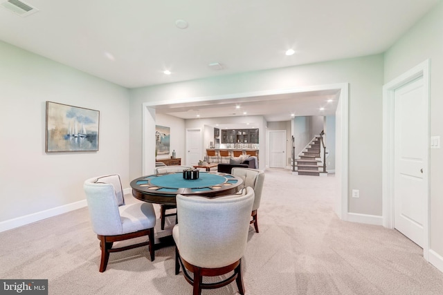 dining space with light colored carpet