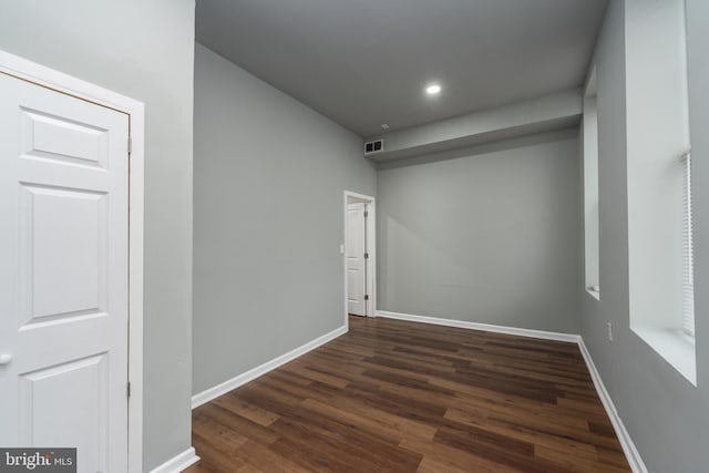 unfurnished room featuring dark wood-type flooring