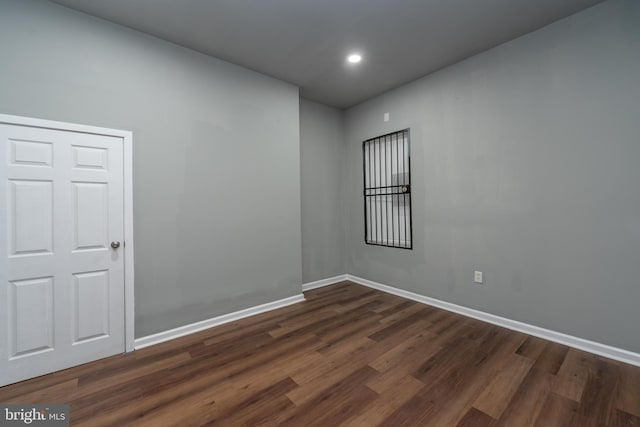 empty room with dark hardwood / wood-style floors