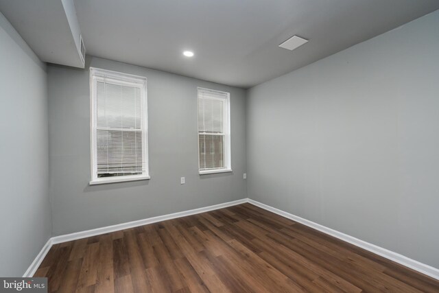 spare room featuring dark hardwood / wood-style flooring