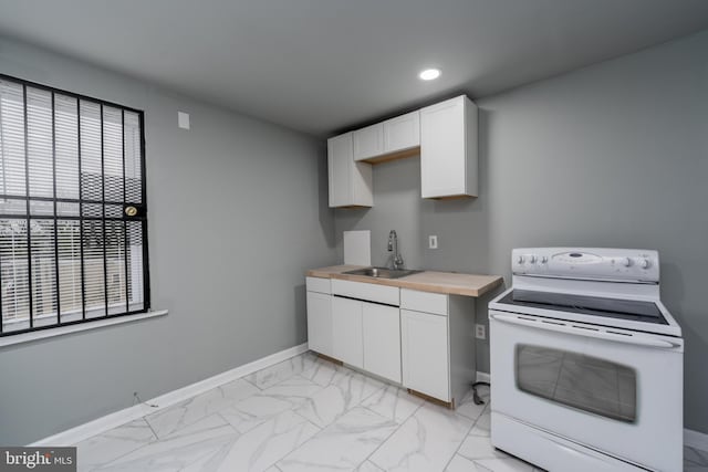 kitchen featuring butcher block countertops, sink, light tile floors, white cabinets, and white electric range