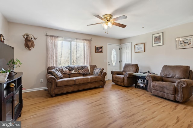 living room featuring light hardwood / wood-style floors and ceiling fan