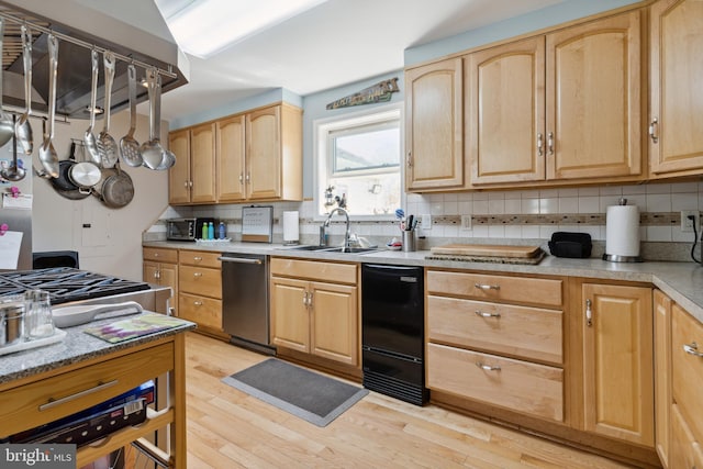 kitchen with light brown cabinets, light wood-type flooring, tasteful backsplash, and dishwasher