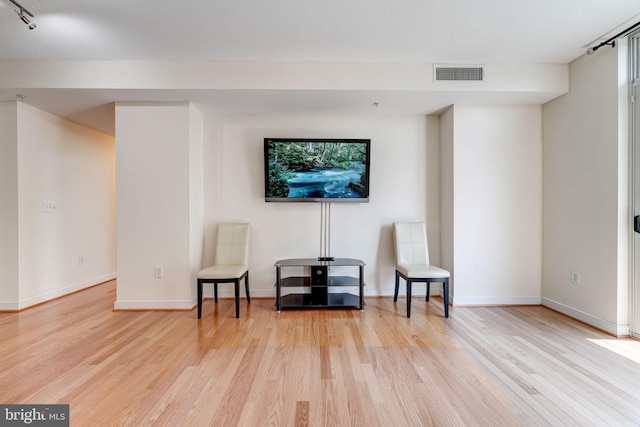 sitting room featuring track lighting and light wood-type flooring