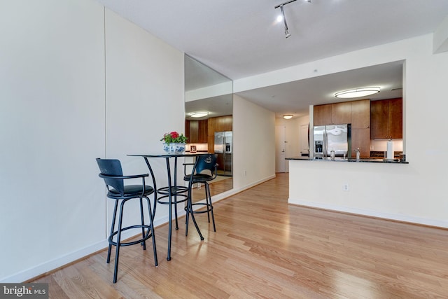 interior space featuring rail lighting and light wood-type flooring